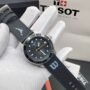 A sleek black Tissot watch with a leather strap, displayed on a white-gloved hand, showcasing its modern design and precise details.